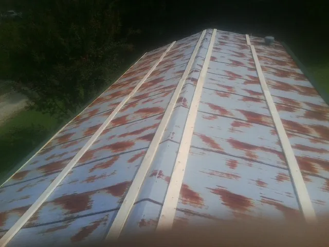 Rusted metal roof panels with new wood purlins before replacement — Storm Damage Roof Repair in Somerdale by Roofing Brothers