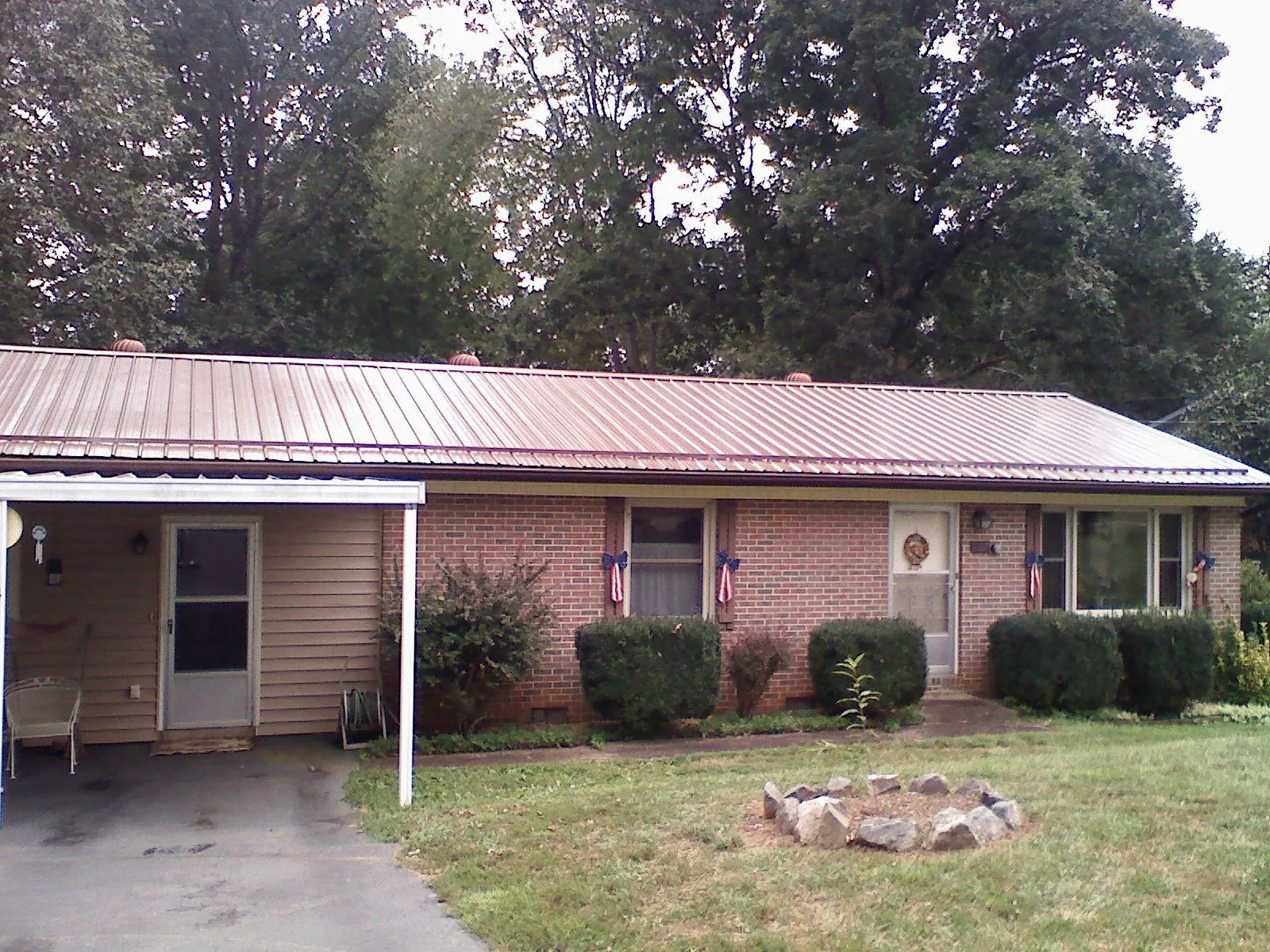 Bronze metal roof and carport on a brick ranch home — Roof Repair work by our crew in Somerdale